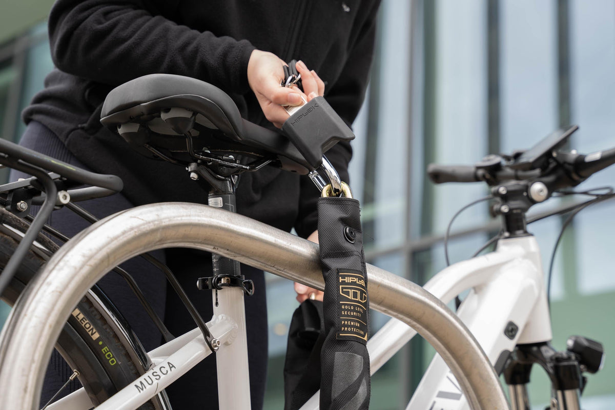 Hiplok GOLD Wearable Chain Lock securing an e-bike to a stand