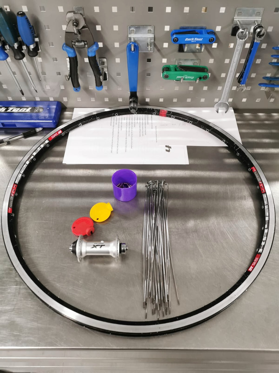 A wheel being built by hand at Aztecs Bikes, the trade Marco learned before the shop existed