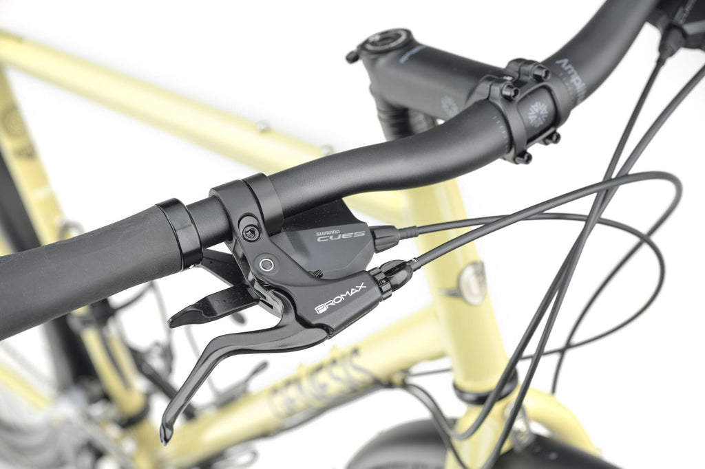 Flat handlebar cockpit with Shimano CUES shifter and brake lever on the Genesis Tour de Fer 10